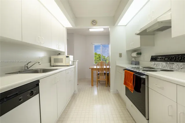 a kitchen with a sink and stove top oven