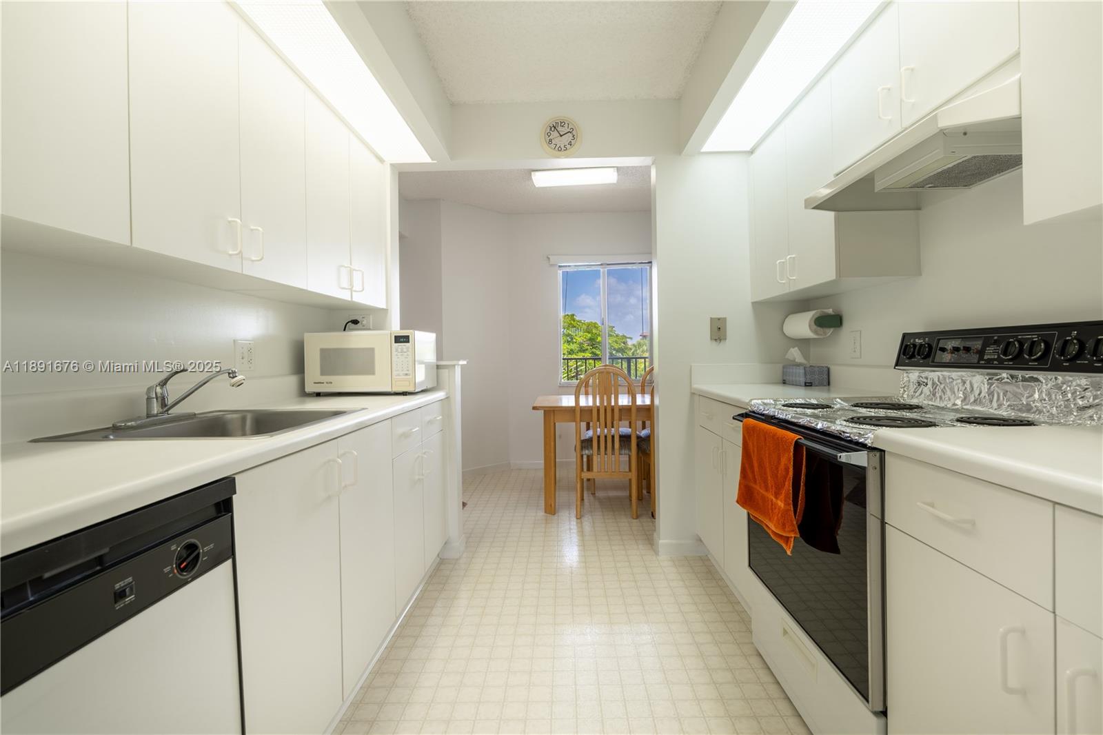 13700 Southwest 11th Street, Unit 309A Pembroke Pines, FL 33027 - Photo 9 of 31 a kitchen with a sink and stove top oven