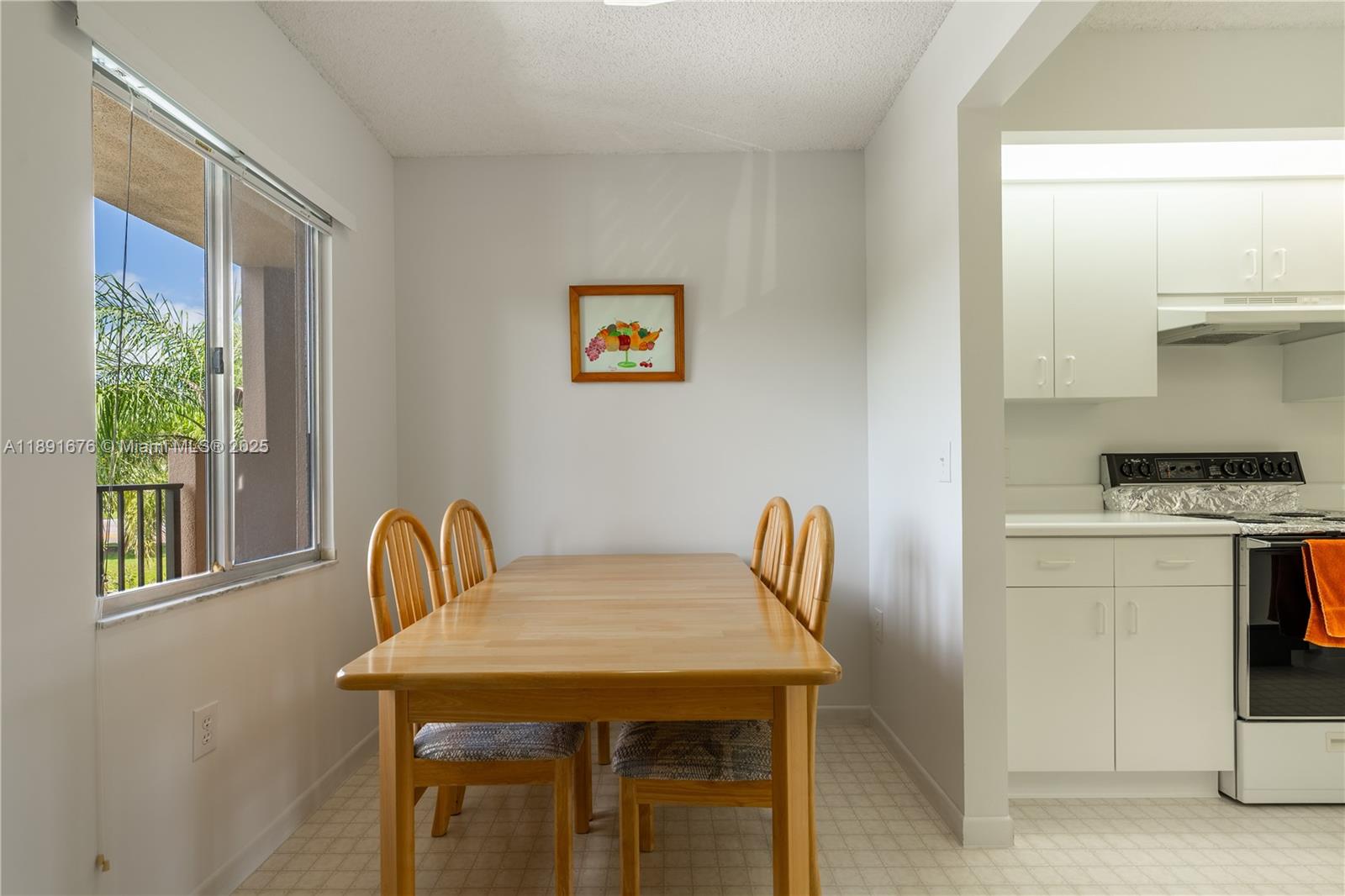 13700 Southwest 11th Street, Unit 309A Pembroke Pines, FL 33027 - Photo 10 of 31 a view of a kitchen area with furniture and wooden floor