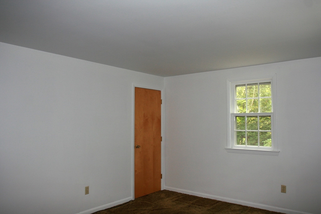 19 Oriole Lane Barnstable, MA 02648 - Photo 29 of 40 a view of an empty room with wooden floor and a window