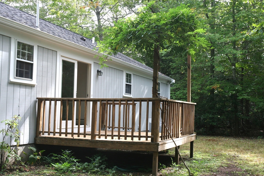 19 Oriole Lane Barnstable, MA 02648 - Photo 38 of 40 a view of a wooden deck that has a bench