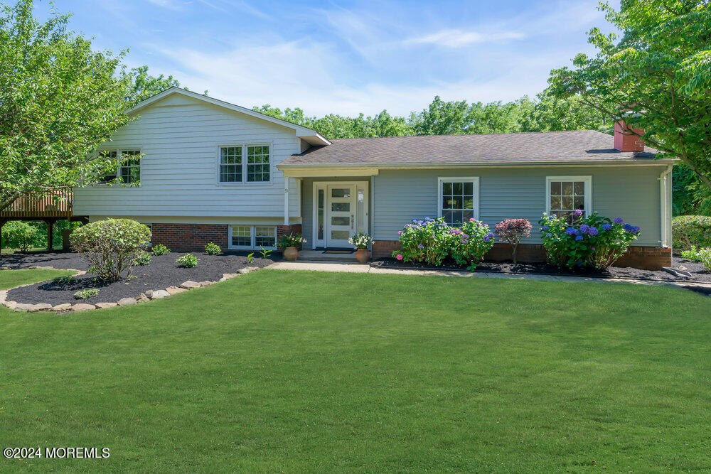 a front view of house with yard and green space