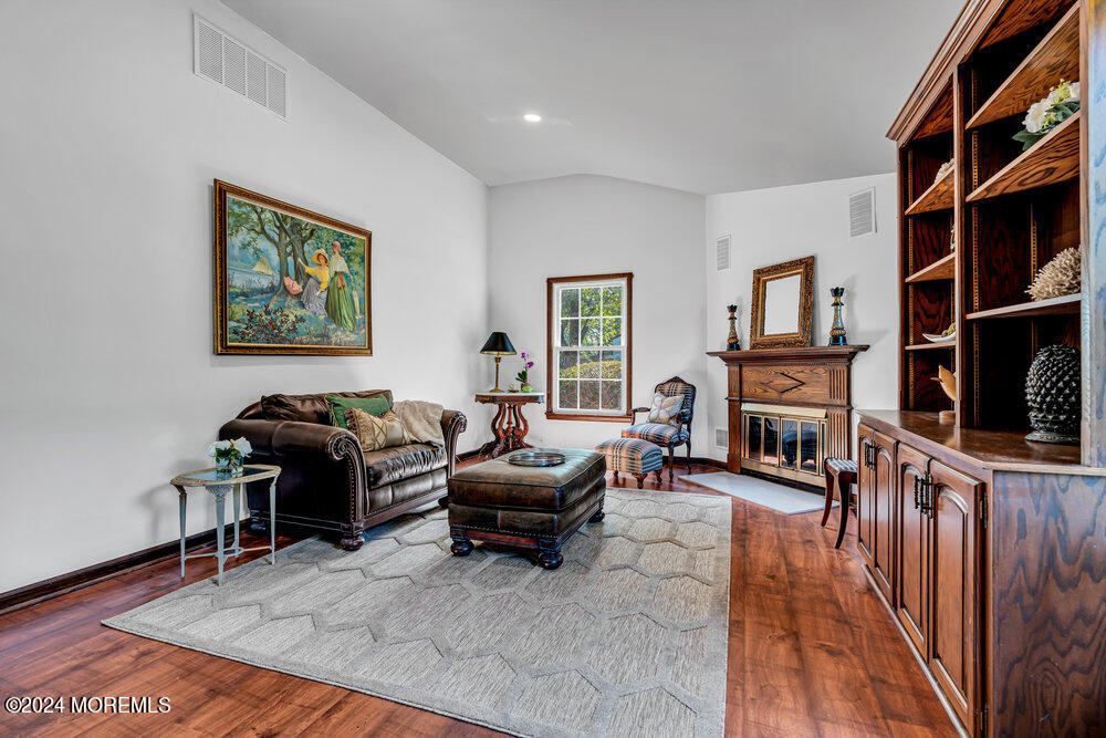 9 Comanche Drive Middletown, NJ 07716 - Photo 11 of 69 a living room with furniture a fireplace and a flat screen tv