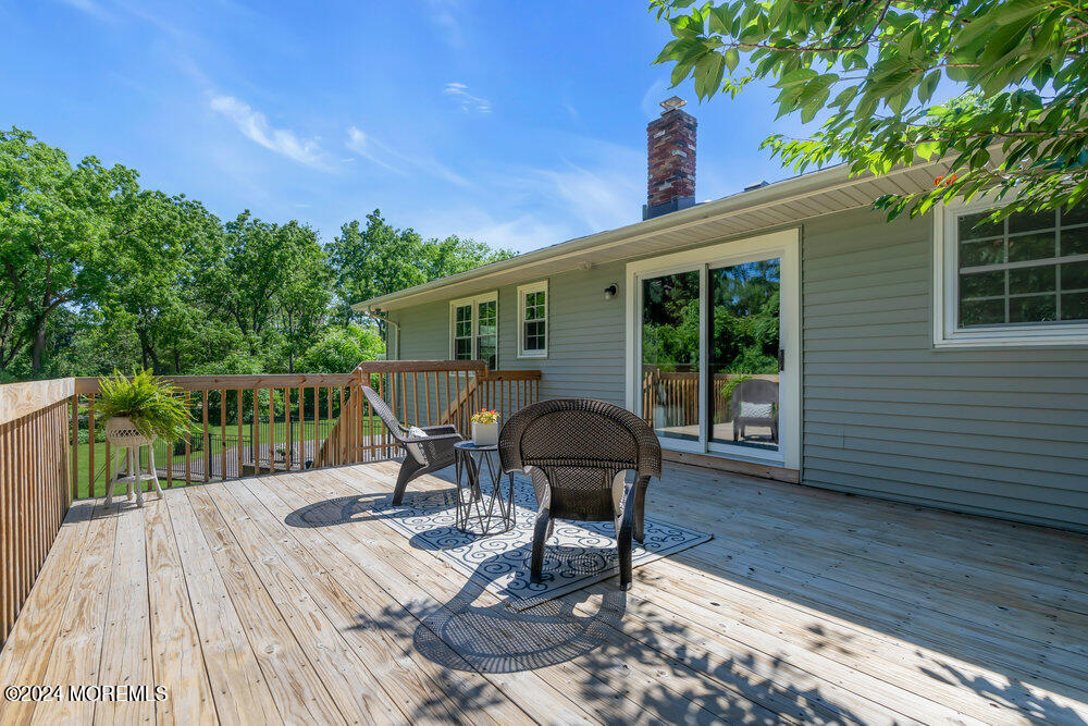 9 Comanche Drive Middletown, NJ 07716 - Photo 26 of 69 a view of a roof deck with table and chairs and wooden floor