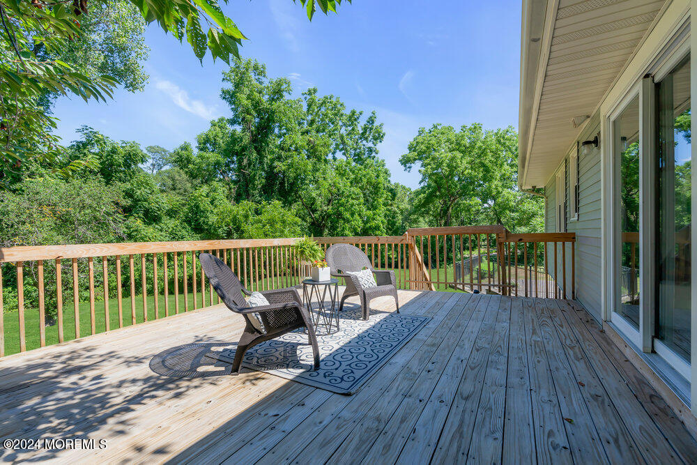 9 Comanche Drive Middletown, NJ 07716 - Photo 28 of 69 a view of a deck with two chair and wooden floor
