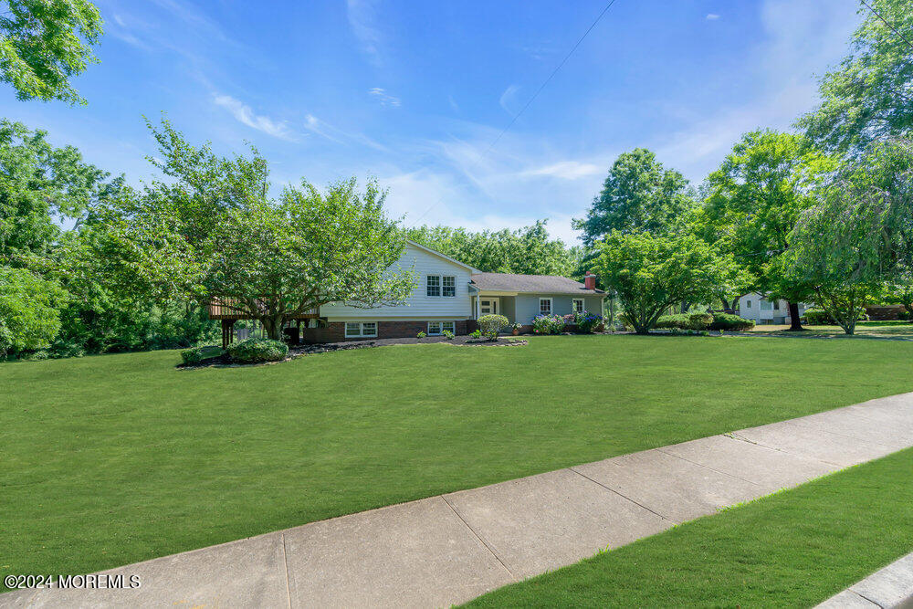 9 Comanche Drive Middletown, NJ 07716 - Photo 3 of 69 a front view of a house with garden