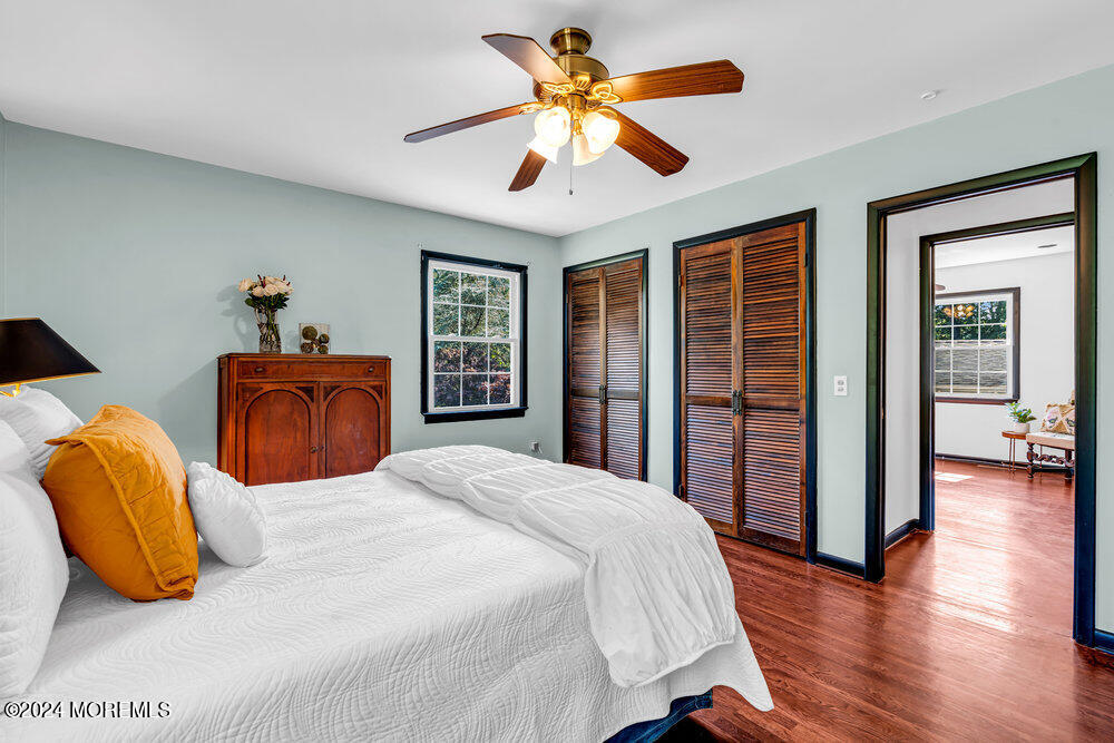 9 Comanche Drive Middletown, NJ 07716 - Photo 34 of 69 a bedroom with a large bed and a chandelier