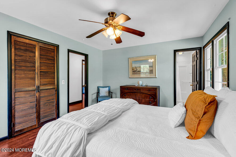 9 Comanche Drive Middletown, NJ 07716 - Photo 35 of 69 a bedroom with a bed and a chandelier