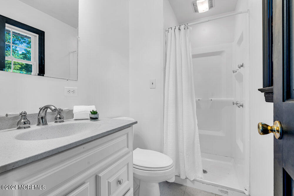 9 Comanche Drive Middletown, NJ 07716 - Photo 36 of 69 a bathroom with a sink toilet and shower