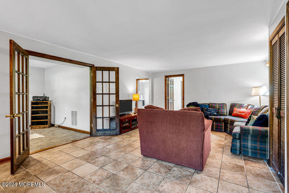 9 Comanche Drive Middletown, NJ 07716 - Photo 37 of 69 a living room with furniture a bookshelf and a window