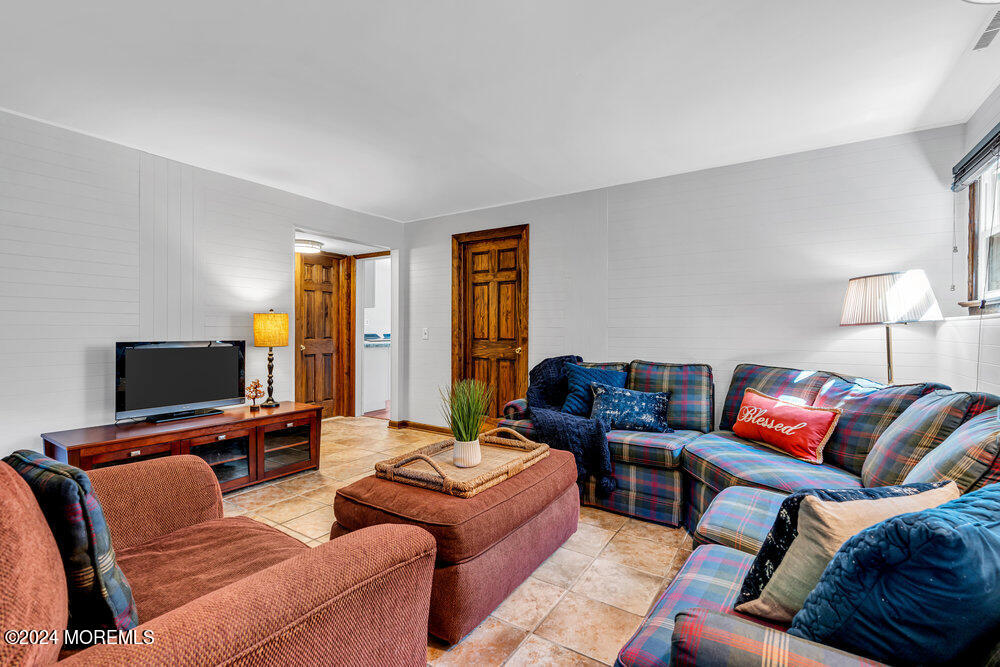 9 Comanche Drive Middletown, NJ 07716 - Photo 40 of 69 a living room with furniture and a flat screen tv