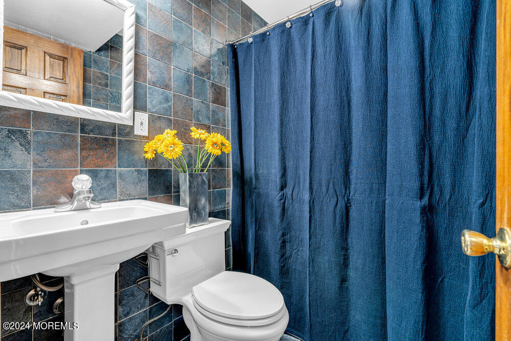 9 Comanche Drive Middletown, NJ 07716 - Photo 47 of 69 a bathroom with a sink a toilet and shower