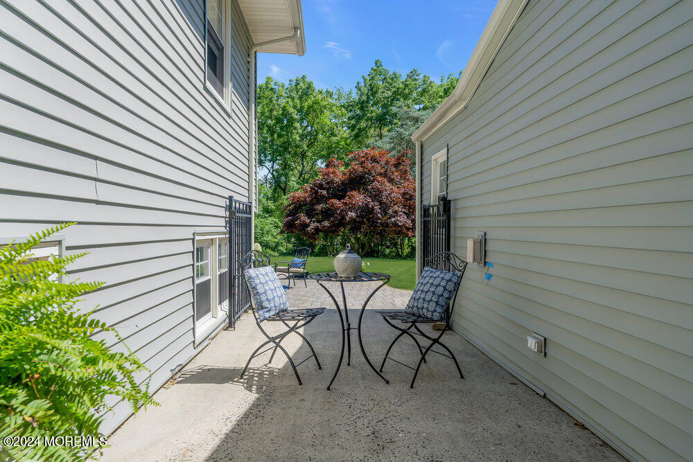 9 Comanche Drive Middletown, NJ 07716 - Photo 52 of 69 a view of a patio with a table and chairs and potted plants