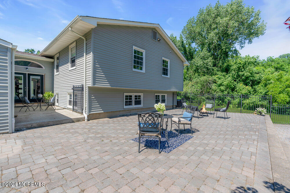 9 Comanche Drive Middletown, NJ 07716 - Photo 55 of 69 a view of a house with a patio and a yard