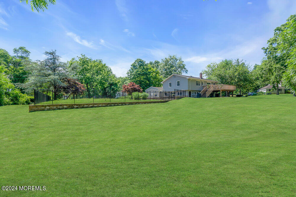9 Comanche Drive Middletown, NJ 07716 - Photo 59 of 69 a backyard of a house with lots of green space and fountain