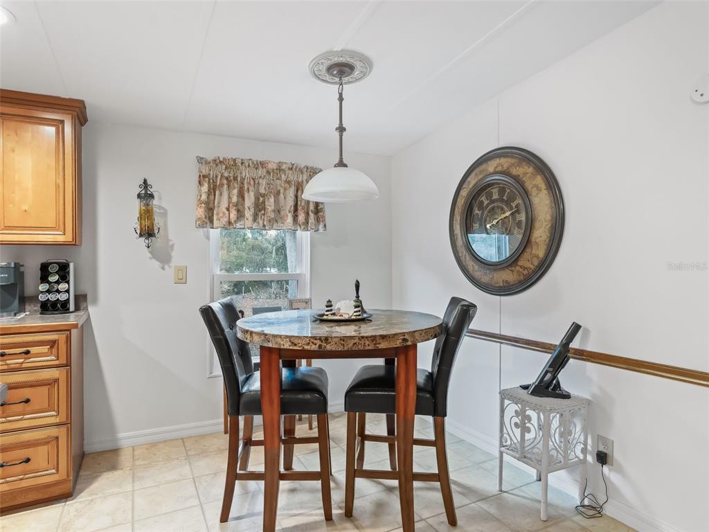 16160 Southeast 97th Terrace Road Summerfield, FL 34491 - Photo 11 of 39 a view of a dining room with furniture and a chandelier