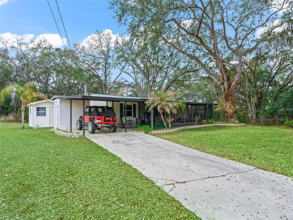 16160 Southeast 97th Terrace Road Summerfield, FL 34491 - Photo 2 of 39 a view of a house with a yard