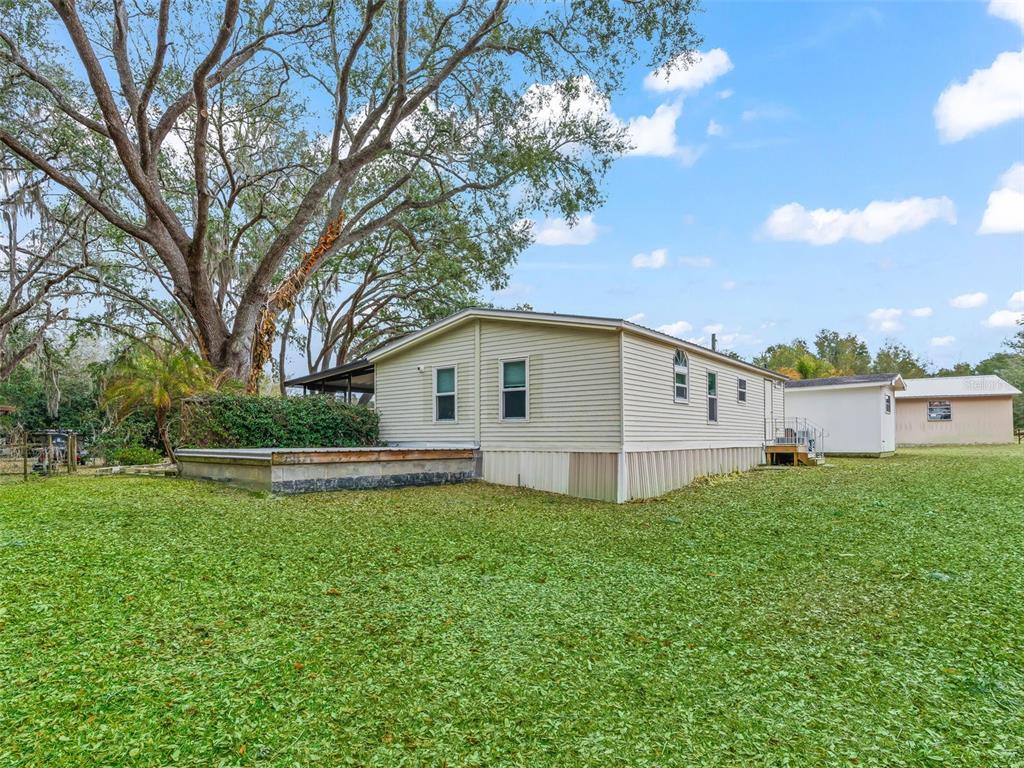 16160 Southeast 97th Terrace Road Summerfield, FL 34491 - Photo 23 of 39 a view of a house with a yard