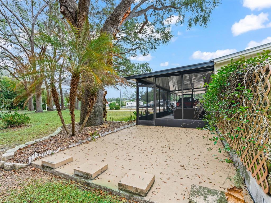 16160 Southeast 97th Terrace Road Summerfield, FL 34491 - Photo 24 of 39 a view of a backyard with a garden and plants