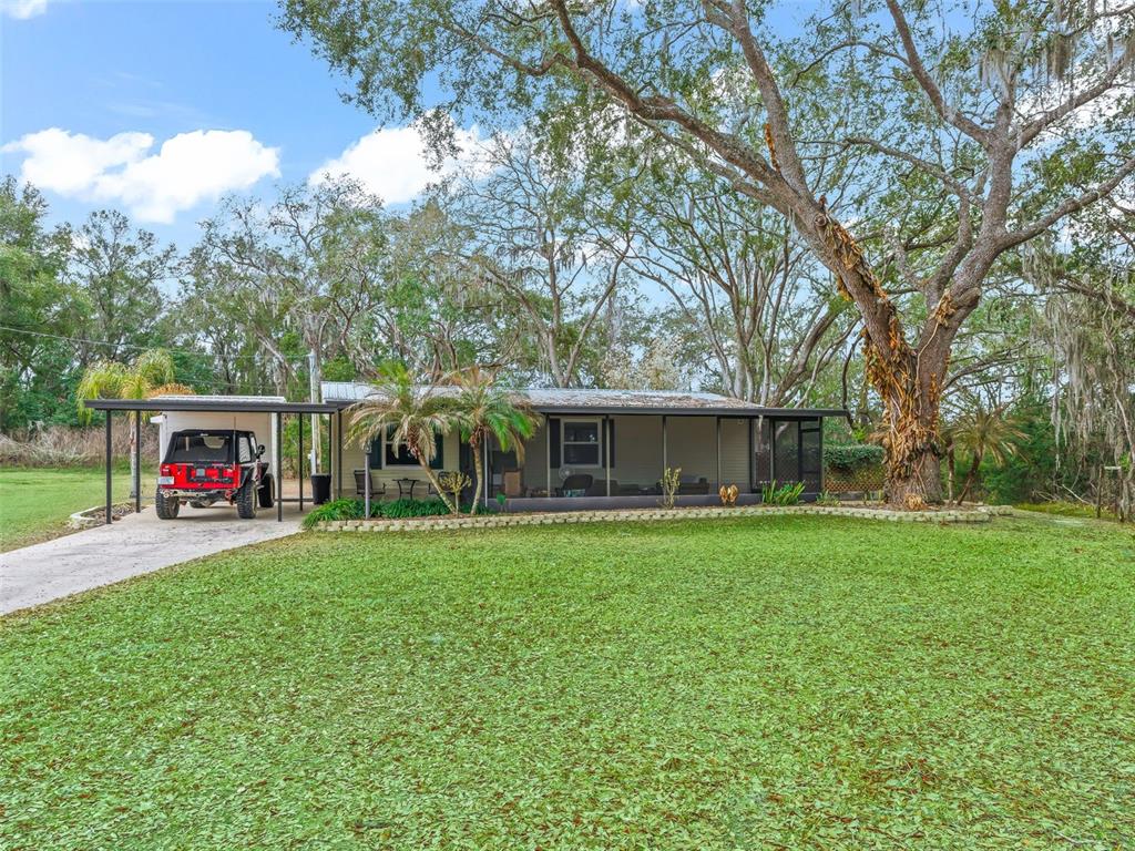16160 Southeast 97th Terrace Road Summerfield, FL 34491 - Photo 3 of 39 a view of a house with backyard and garden