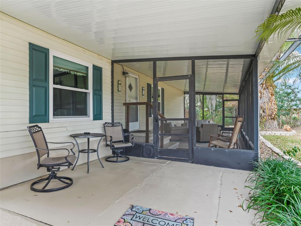 16160 Southeast 97th Terrace Road Summerfield, FL 34491 - Photo 4 of 39 a building outdoor space with patio furniture and a potted plant