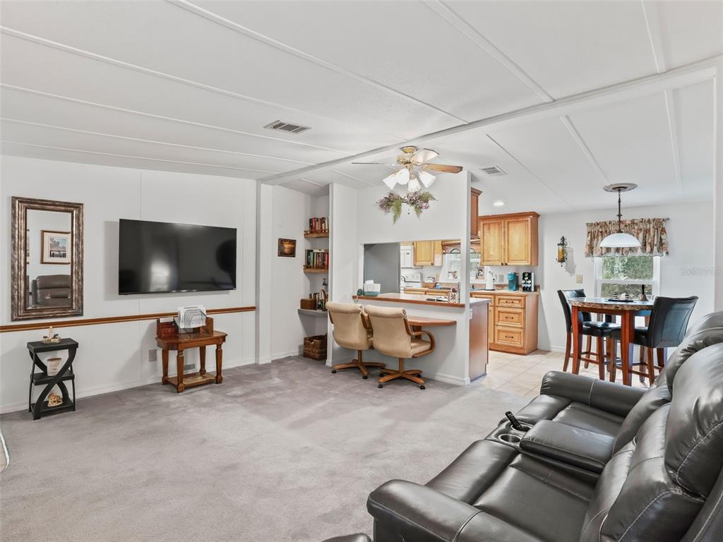 16160 Southeast 97th Terrace Road Summerfield, FL 34491 - Photo 9 of 39 a living room with furniture and a flat screen tv