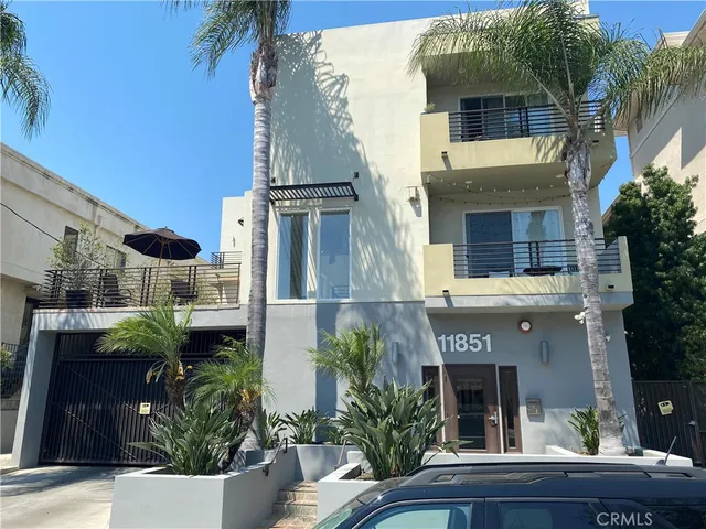 a front view of a house with plants