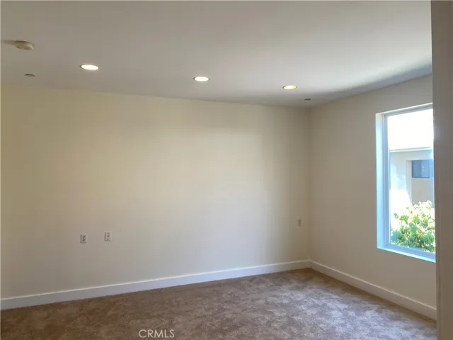 an empty room with closet and a bathroom