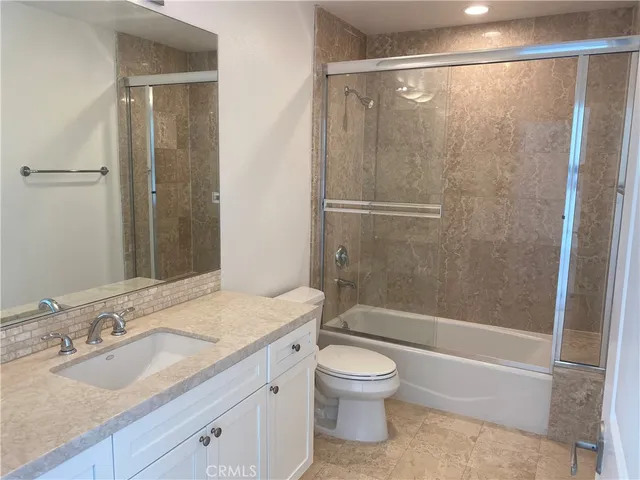 a view of a house with a balcony and wooden floor