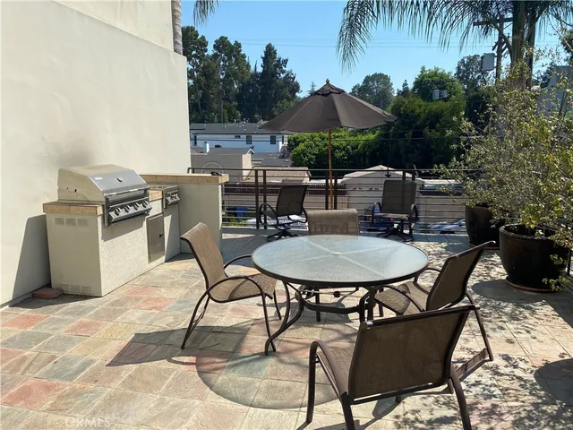 a room with gym equipment and lots of windows