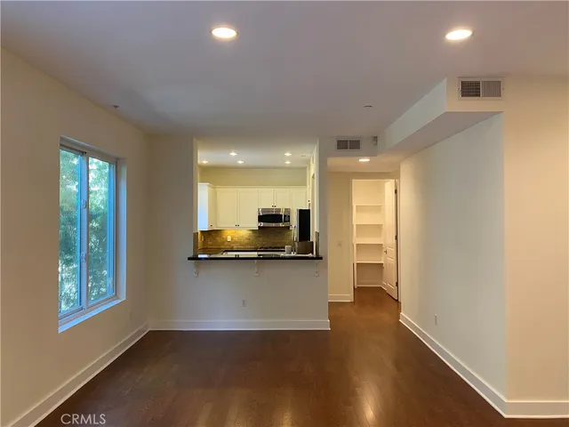 a kitchen with stainless steel appliances a refrigerator and a stove top oven