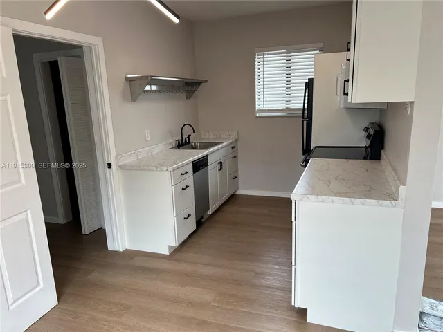 a kitchen with a sink a stove and refrigerator