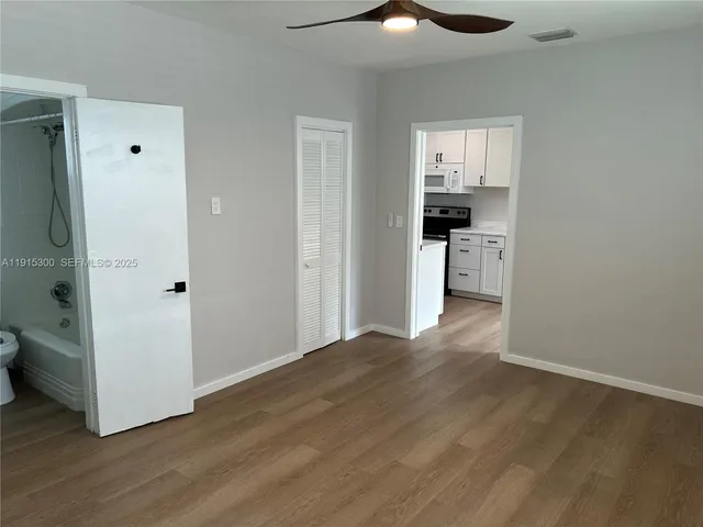 a view of a kitchen with a refrigerator and a stove top oven