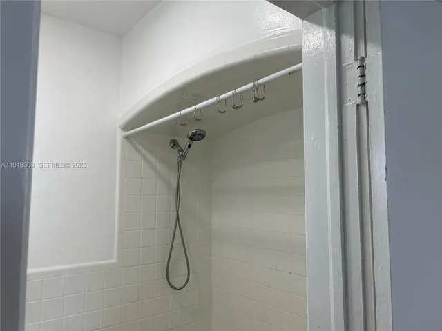 a bathroom with a glass shower door
