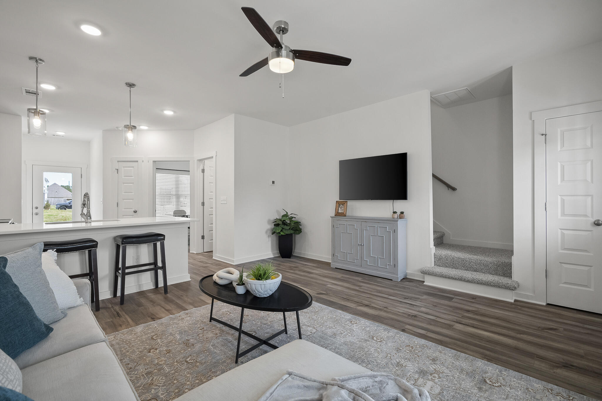 Lot 38 Sweethorn Street DeFuniak Springs, FL 32435 - Photo 6 of 29 a living room with furniture a flat screen tv and kitchen view