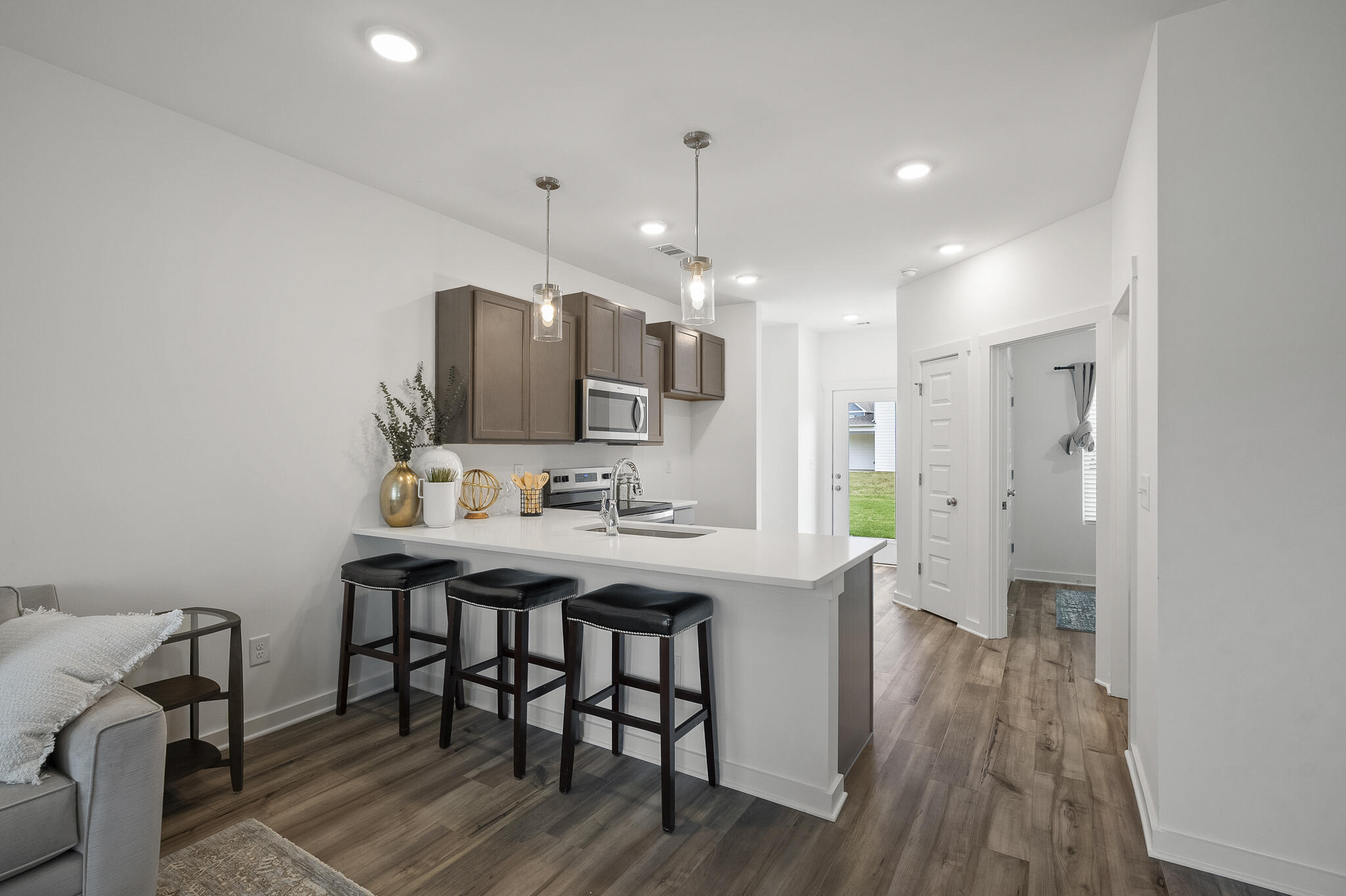 Lot 38 Sweethorn Street DeFuniak Springs, FL 32435 - Photo 7 of 29 a kitchen with stainless steel appliances a dining table chairs and wooden floor