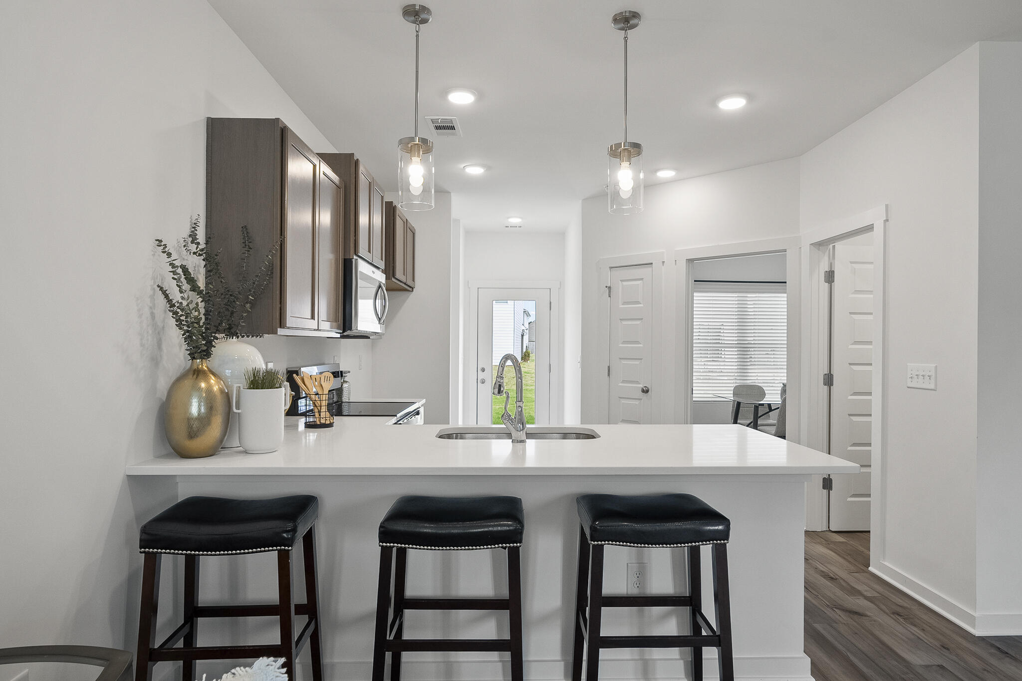 Lot 38 Sweethorn Street DeFuniak Springs, FL 32435 - Photo 8 of 29 a kitchen with kitchen island granite countertop a sink and a refrigerator