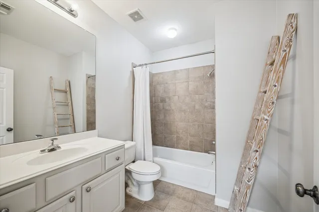 a bathroom with a double vanity sink toilet mirror and bathtub