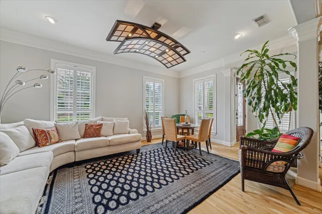 a view of a hallway with a livingroom and dinning area with chandelier