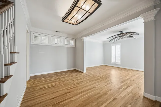 a dining room with furniture and wooden floor