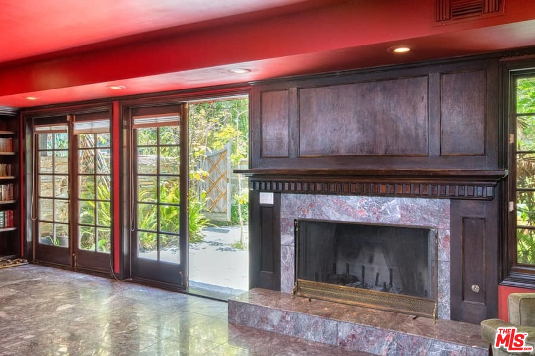 613 North Arden Drive Beverly Hills, CA 90210 - Photo 10 of 25 a living room with a fireplace and a large window