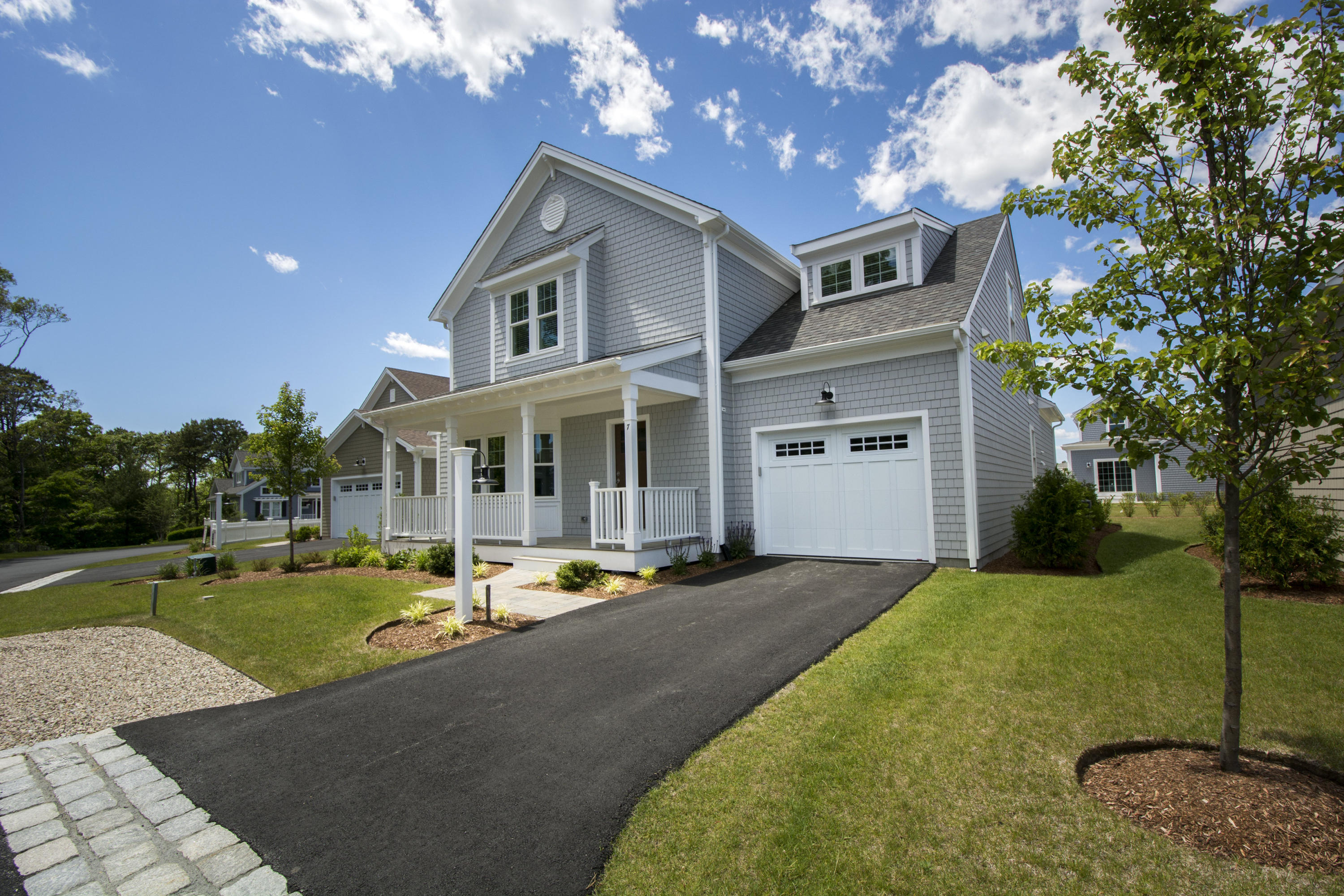 67 Cobblestone Circle Mashpee, MA 02649 - Photo 19 of 38 a front view of a house with a yard table and chairs