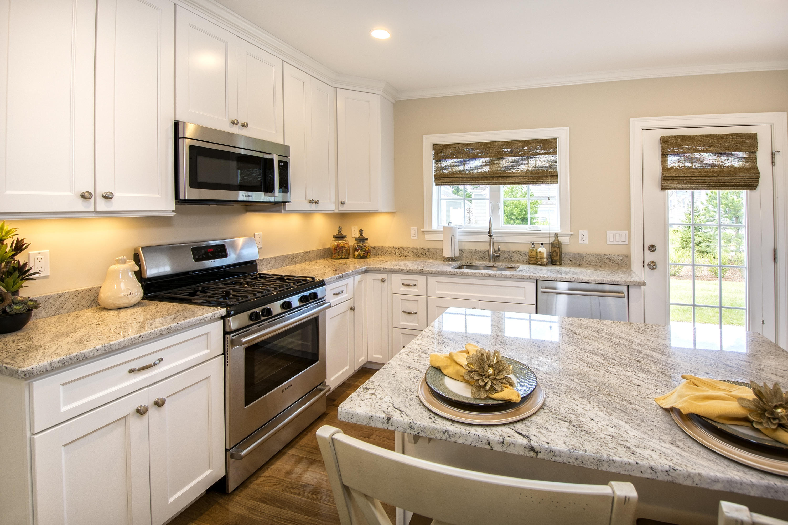 67 Cobblestone Circle Mashpee, MA 02649 - Photo 3 of 38 a kitchen with stainless steel appliances granite countertop a stove a sink and a microwave