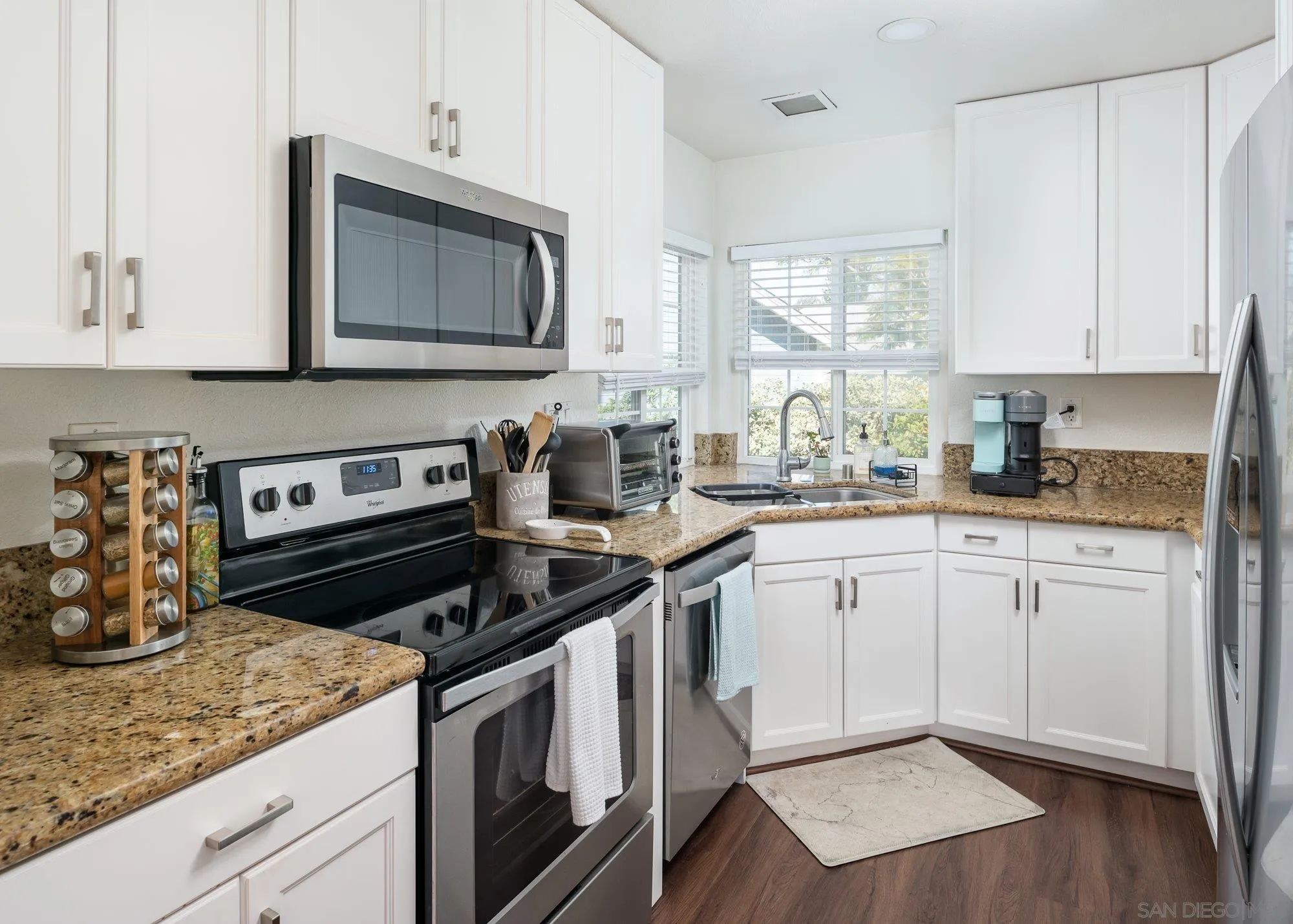 323 Windjammer Circle Chula Vista, CA 91910 - Photo 13 of 27 a kitchen with a sink stove and cabinets