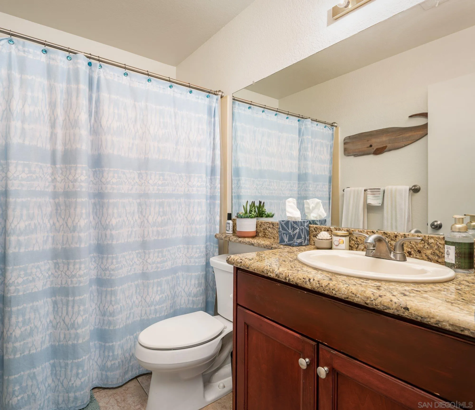 323 Windjammer Circle Chula Vista, CA 91910 - Photo 19 of 27 a bathroom with a granite countertop sink a toilet and a mirror