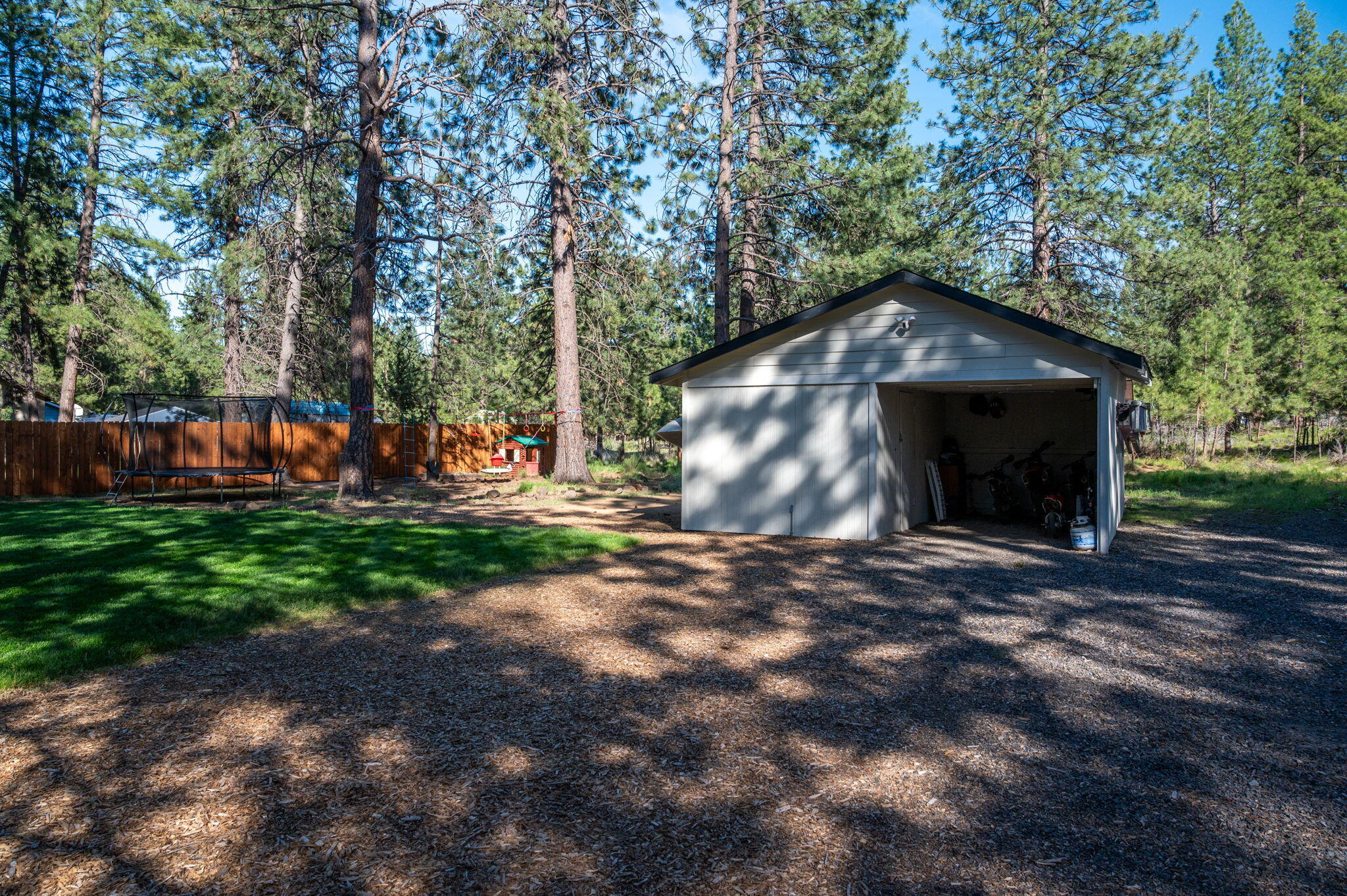 60072 Cinder Butte Road Bend, OR 97702 - Photo 53 of 60 a front view of a house with a yard and a garage