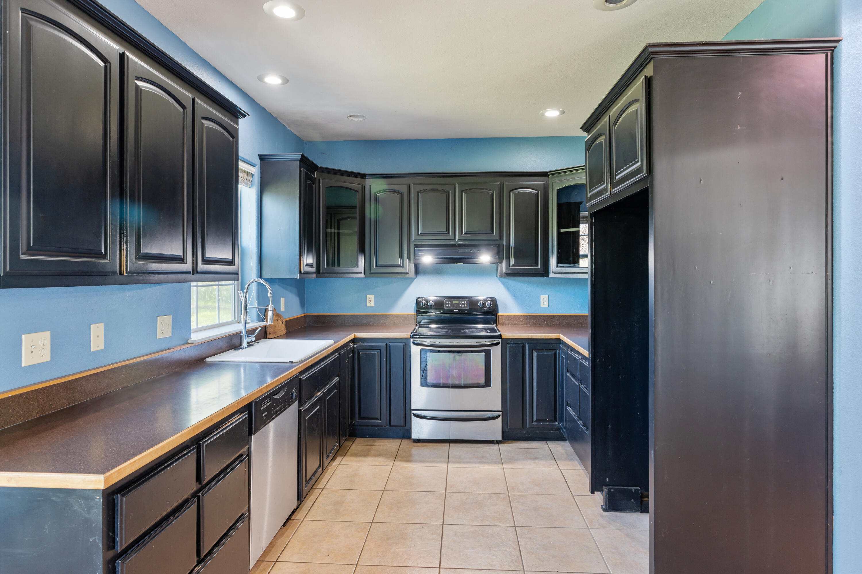 32211 Rock Creek Road Manton, CA 96059 - Photo 9 of 35 a kitchen with stainless steel appliances granite countertop a sink and a stove