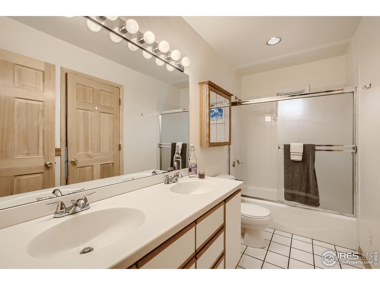 520 Mapleton Avenue Boulder, CO 80302 - Photo 16 of 24 a bathroom with a double vanity sink a toilet and a mirror
