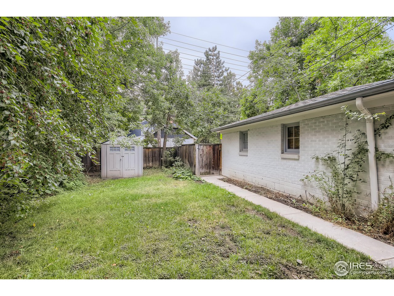 520 Mapleton Avenue Boulder, CO 80302 - Photo 21 of 24 a backyard of a house with a garden and plants