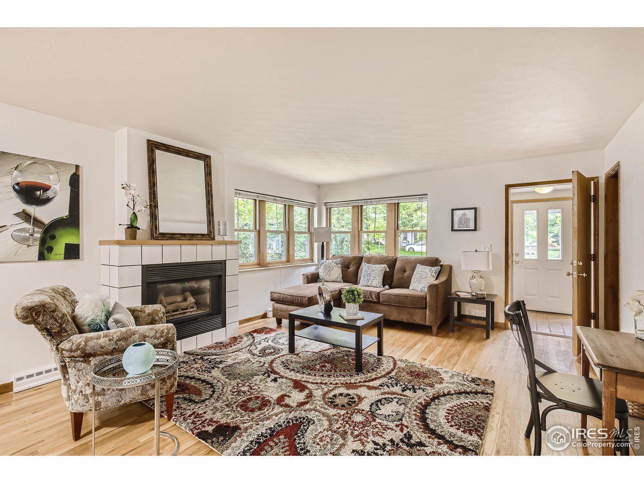 520 Mapleton Avenue Boulder, CO 80302 - Photo 4 of 24 a living room with furniture a fireplace and a large window